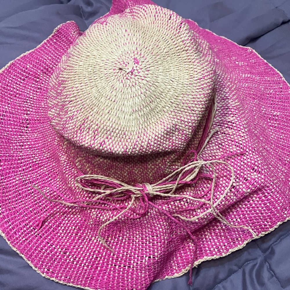 Pink straw beach hat , summer or tropical vacation